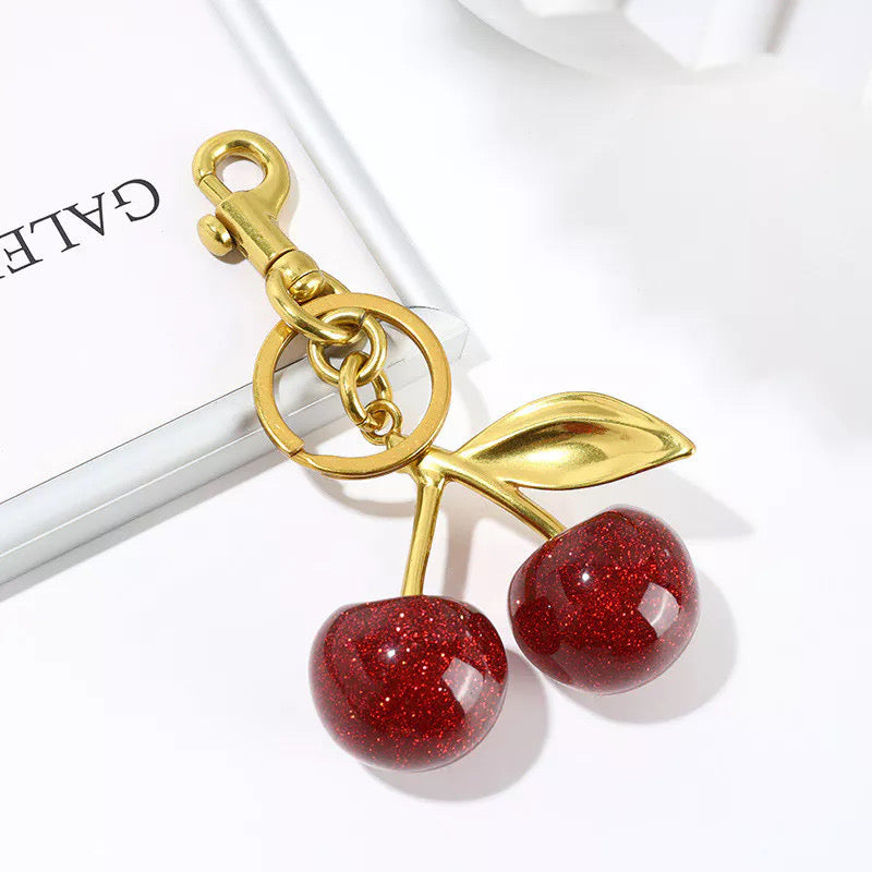 Glittery Cherry Bag Charm attached to handbag
